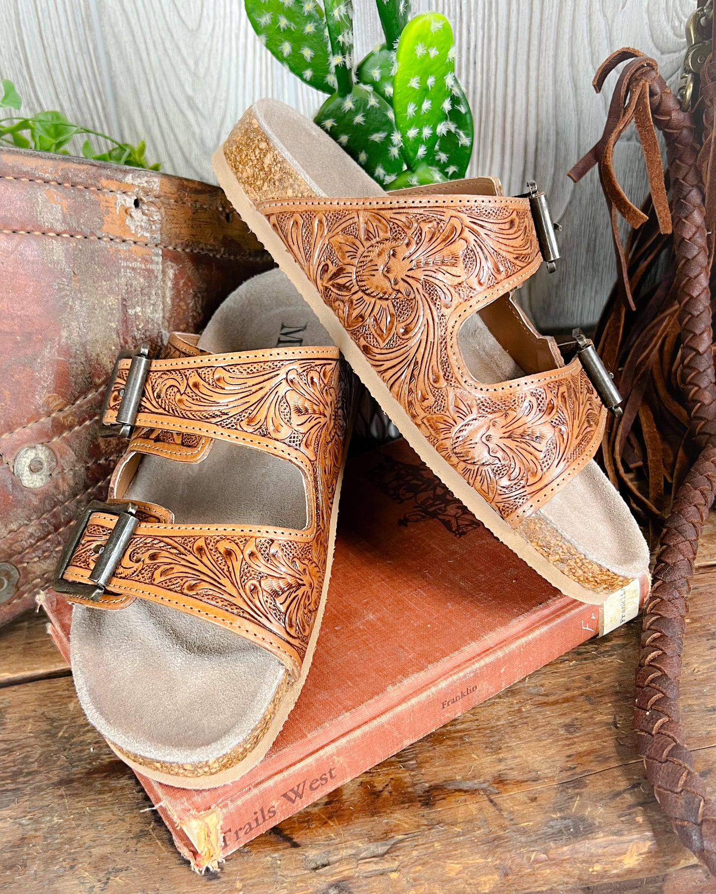 Floral tooled leather Birkenstock-style sandals with adjustable straps and cushioned sole