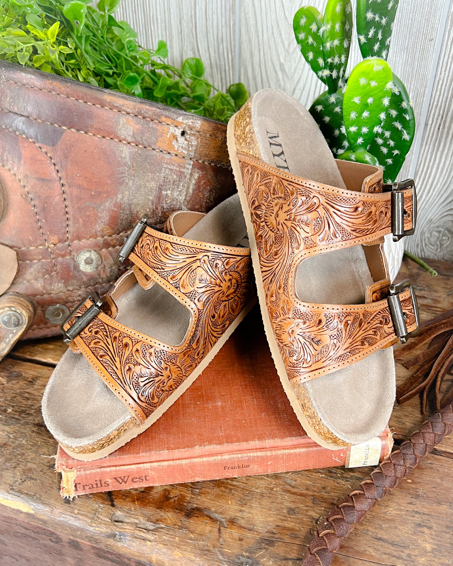 Floral tooled leather Birkenstock-style sandals with adjustable straps and cushioned sole