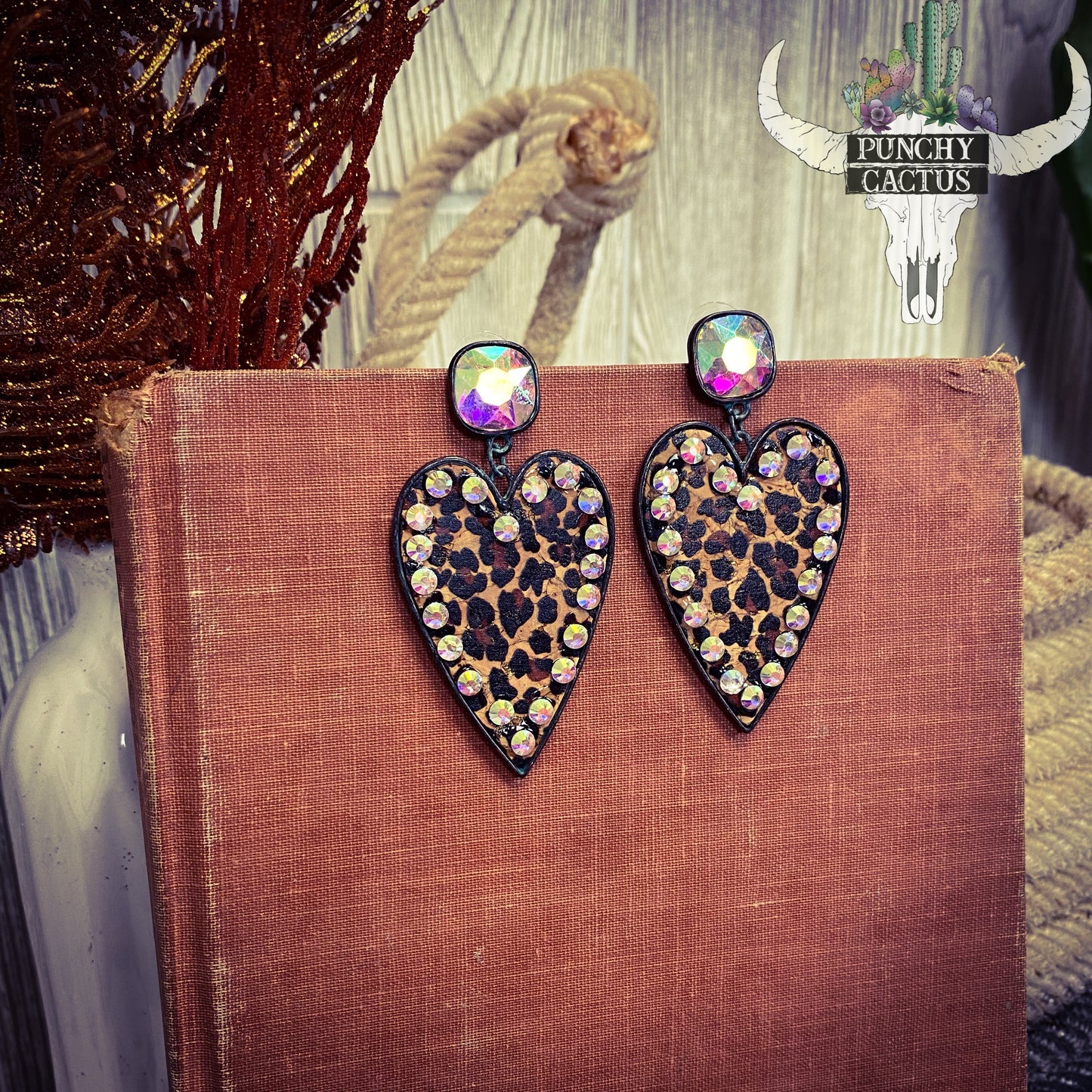 black heart shaped earrings with cheetah print center and rhinestone edge
