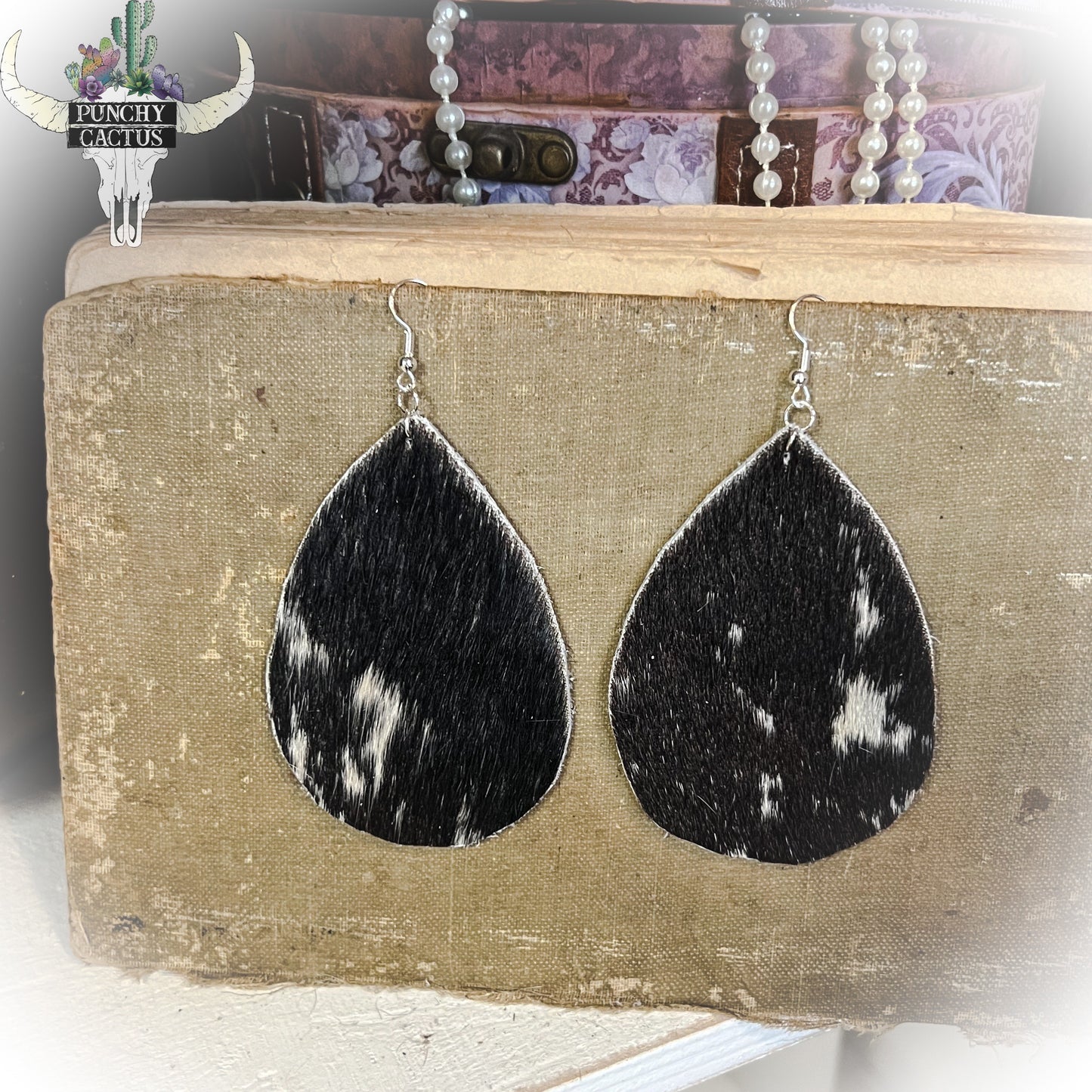 western cowhide hair on hide earrings black with white spots large tear drops