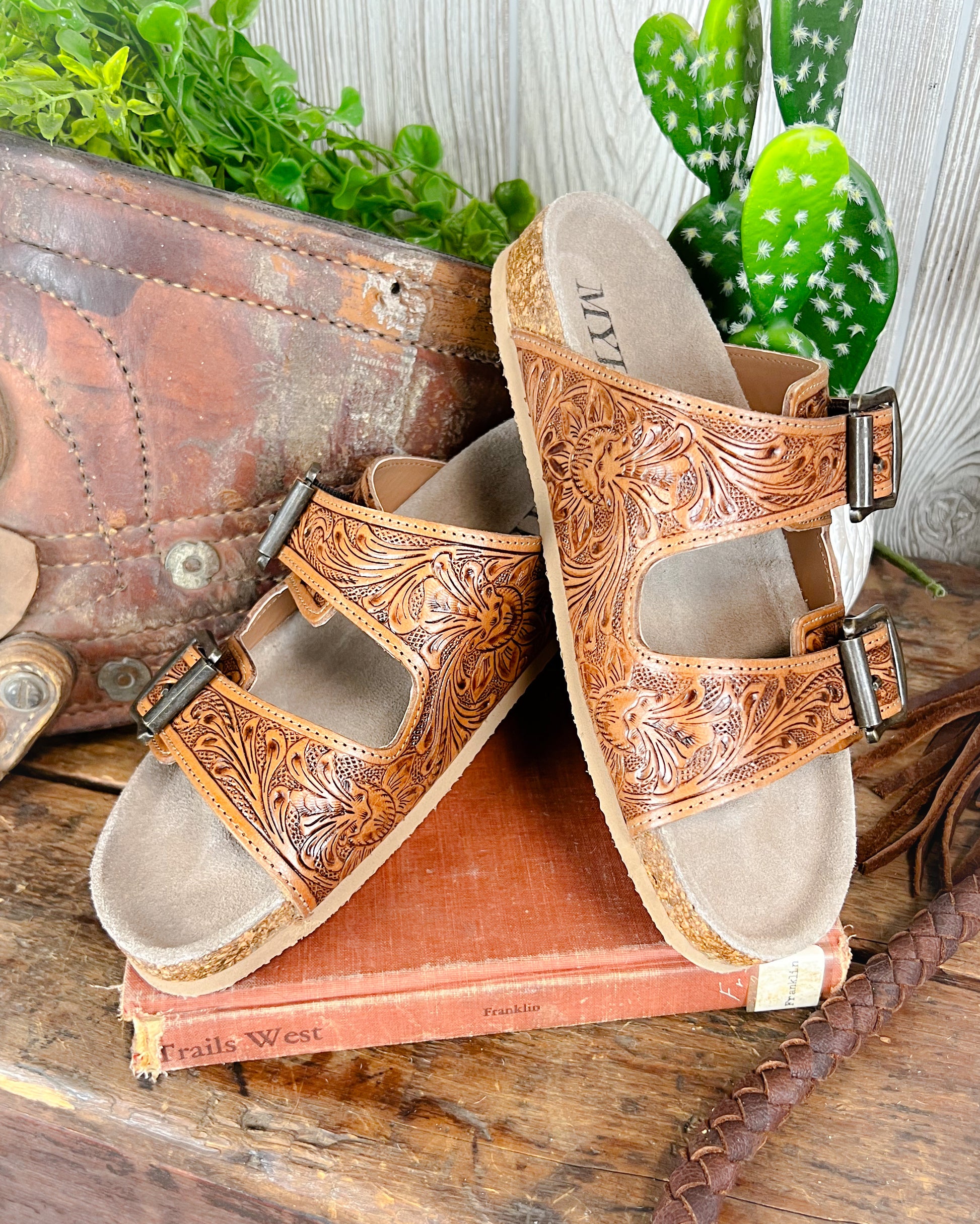 Floral tooled leather Birkenstock-style sandals with adjustable straps and cushioned sole