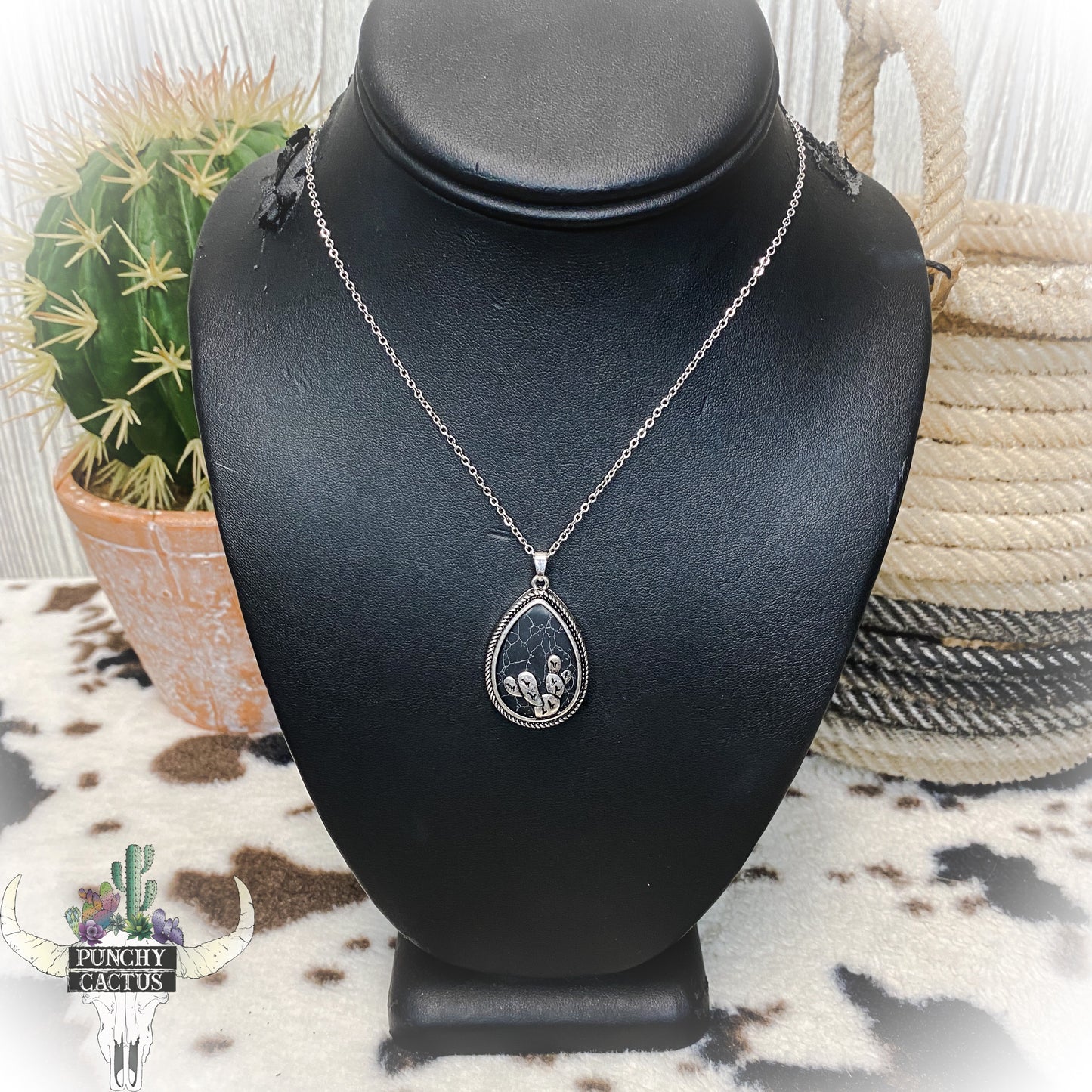 silver western necklace with black teardrop shaped stone and cactus 