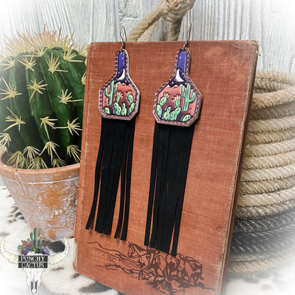 western leather cow tag earrings with cactus tooled design and black leather fringe