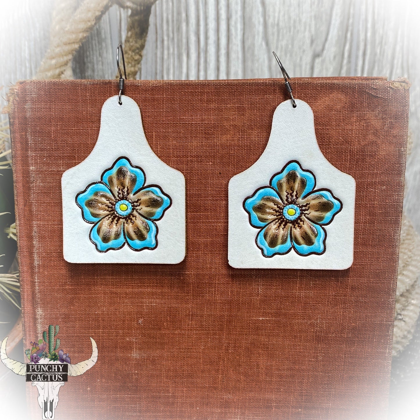 western leather cow tag earrings with flower center tooling - white