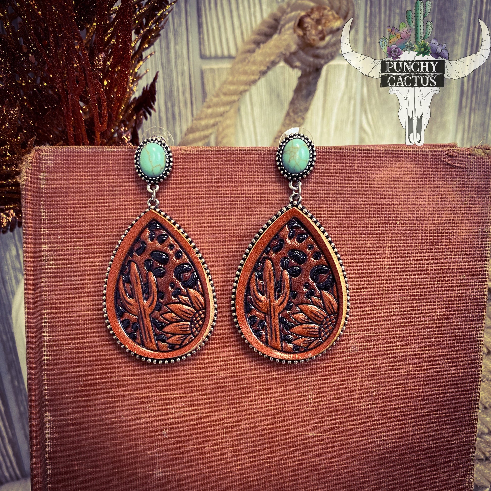 Turquoise stone with tear drop shaped leather tooled earrings  - tooled leather is cheetah print with a cactus and sunflower