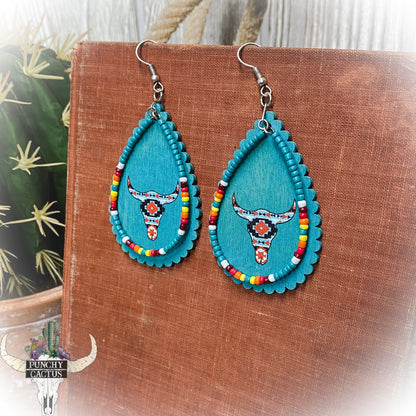 wooden western turquoise earrings with aztec print bull skull and turquoise serape seed bead dangle
